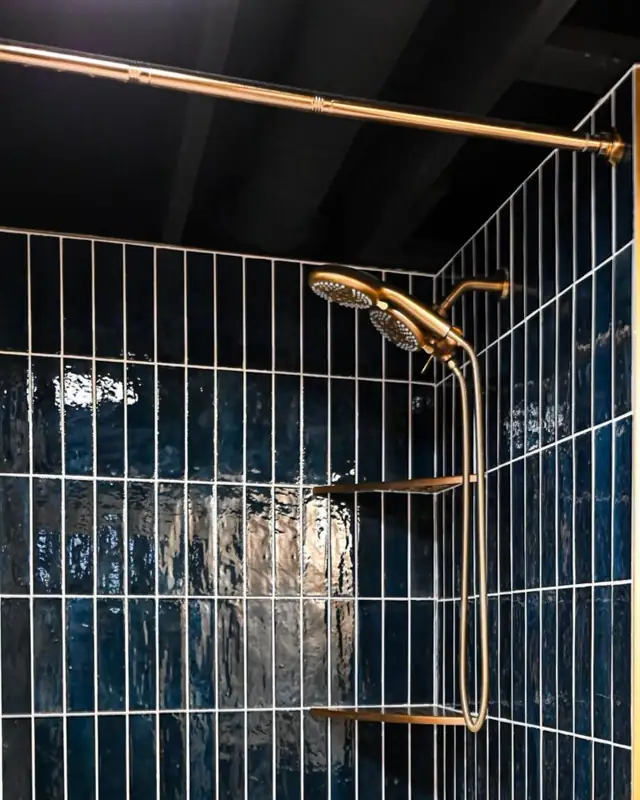Ann Arbor, MI basement bathroom with navy vertical tile and brass shower system