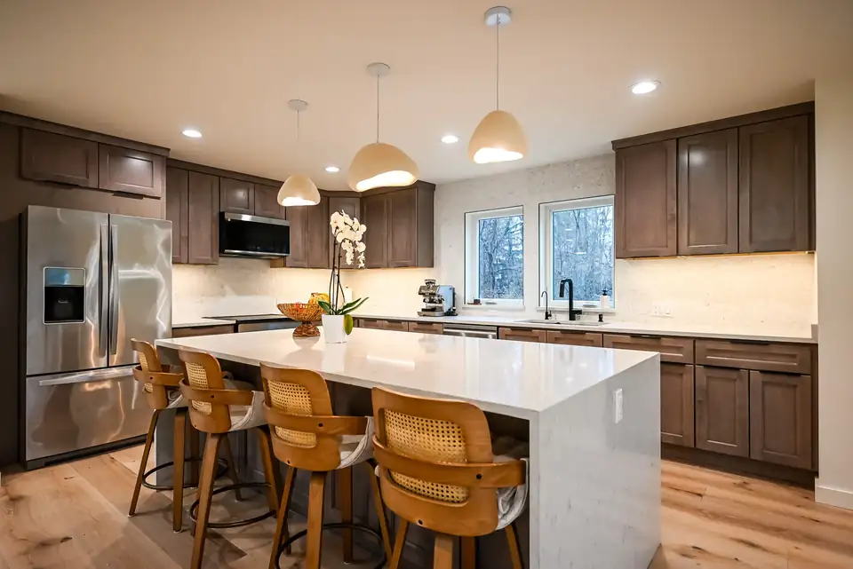 Design-build remodeling Ann Arbor area kitchen by Wright's Renovations: navy cabinets, white quartz counters, gray subway tile backsplash and stainless appliances